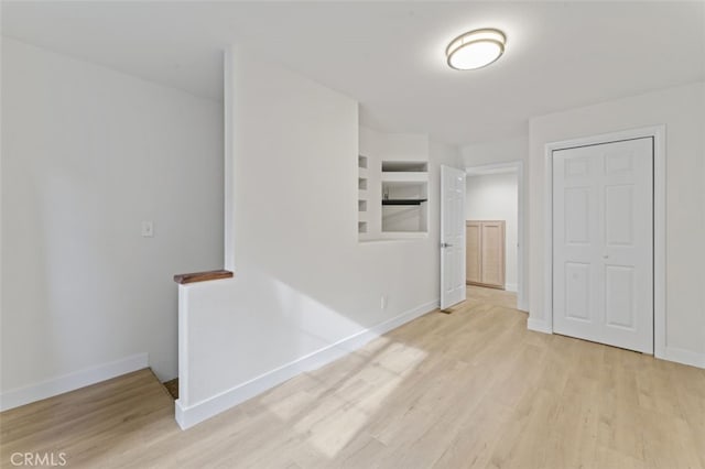 interior space featuring built in features and light wood-type flooring