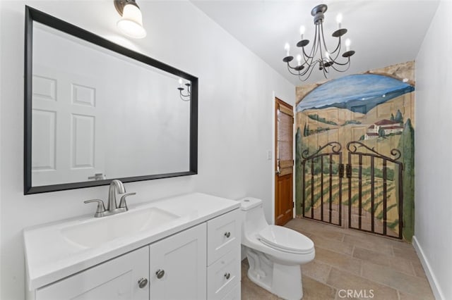 bathroom featuring toilet, vanity, and a notable chandelier