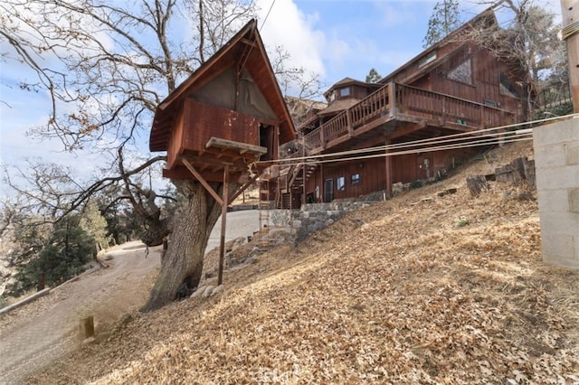 view of side of property with a wooden deck