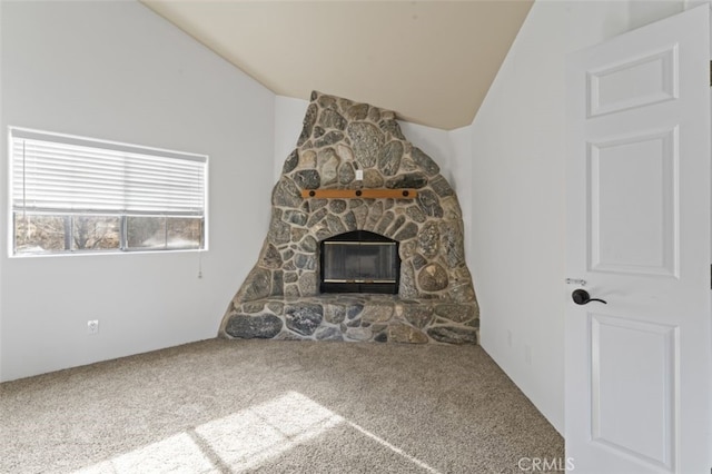 unfurnished living room with lofted ceiling, carpet, and a fireplace