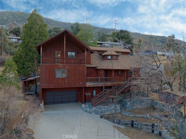 back of property featuring a mountain view and a garage