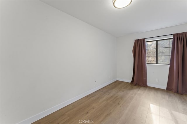 spare room with light wood-type flooring