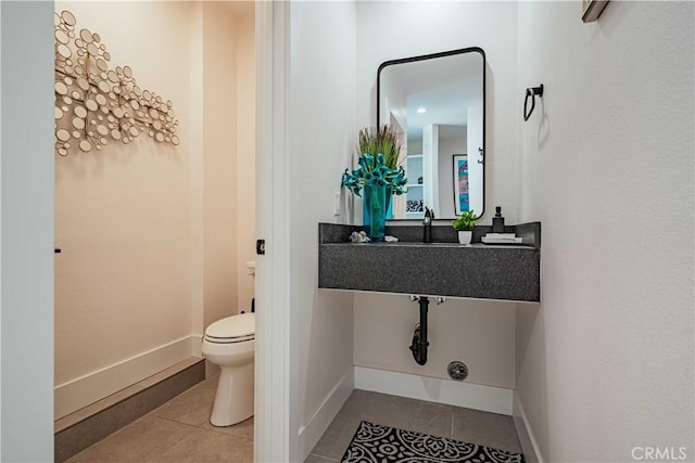 bathroom with tile patterned flooring and toilet