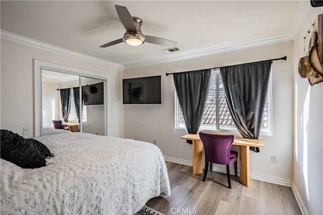 bedroom featuring wood-type flooring, a closet, ceiling fan, and crown molding