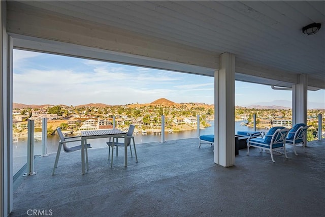 view of patio with a water and mountain view