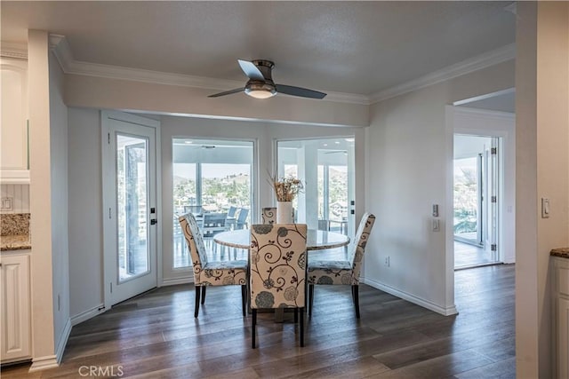 dining room with ornamental molding, dark hardwood / wood-style flooring, ceiling fan, and a healthy amount of sunlight