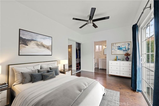 bedroom featuring ceiling fan, dark hardwood / wood-style flooring, and connected bathroom