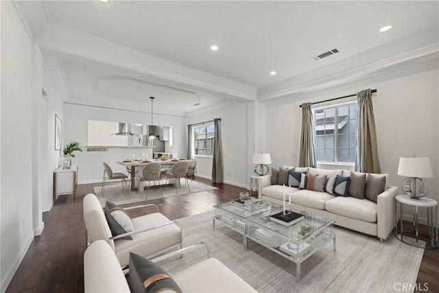 living room with hardwood / wood-style floors and crown molding