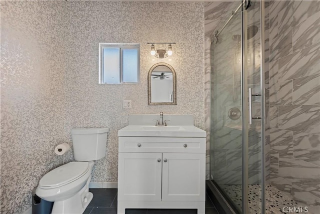 bathroom featuring tile patterned floors, toilet, vanity, and an enclosed shower