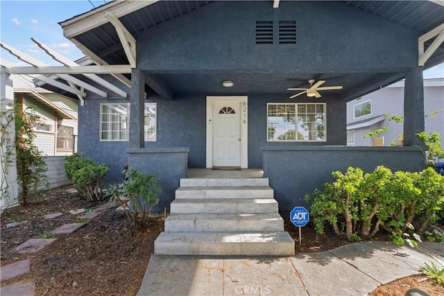 view of exterior entry with ceiling fan