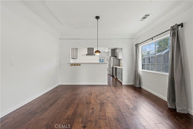 unfurnished living room with dark hardwood / wood-style flooring and ornamental molding