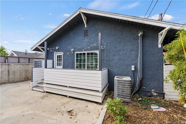 rear view of house featuring central AC and a patio area