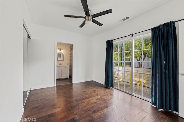 spare room with ceiling fan and dark hardwood / wood-style flooring