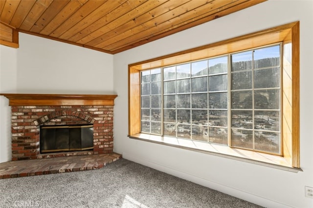 unfurnished living room featuring a brick fireplace, wooden ceiling, and carpet flooring