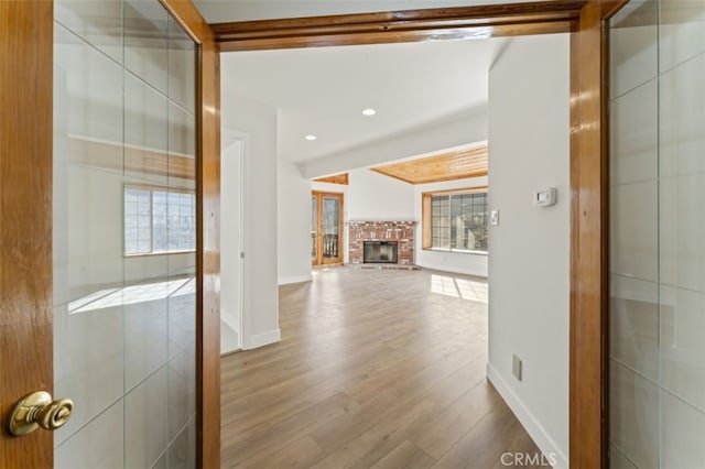 hall featuring a wealth of natural light and hardwood / wood-style flooring