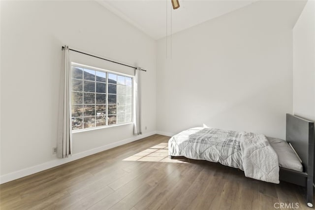 bedroom with ceiling fan and wood-type flooring