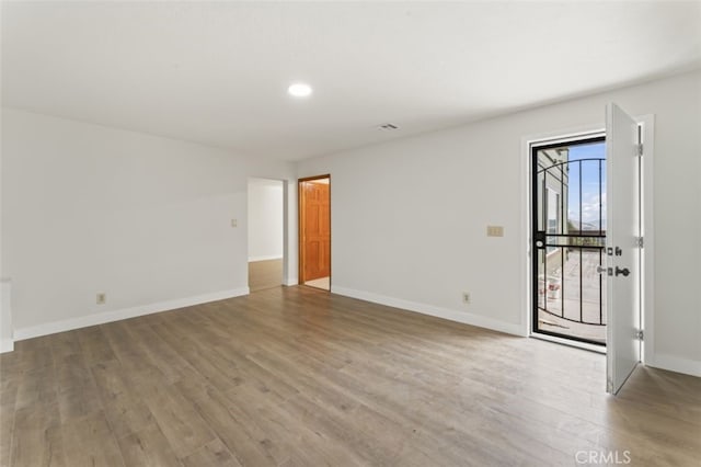 spare room featuring hardwood / wood-style flooring