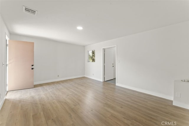 spare room with hardwood / wood-style flooring