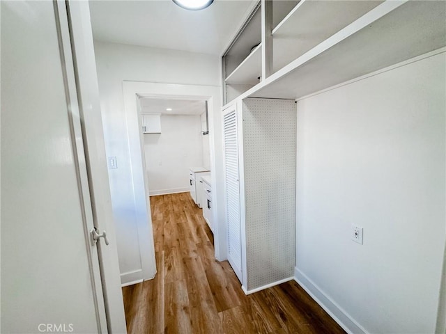 hall with hardwood / wood-style floors