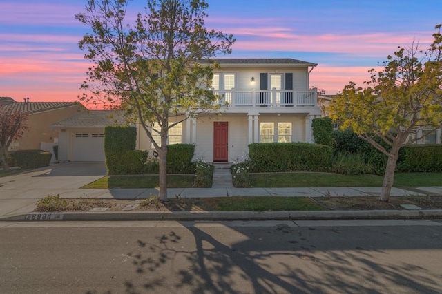 view of front of home with a balcony and a garage