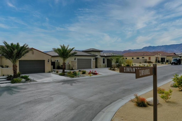 view of front facade with a mountain view and a garage