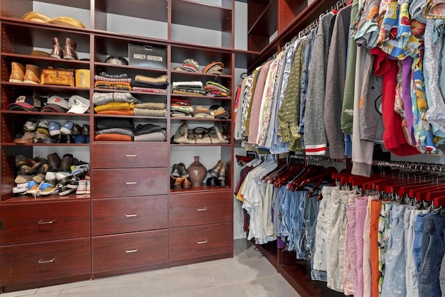 walk in closet with light tile patterned flooring