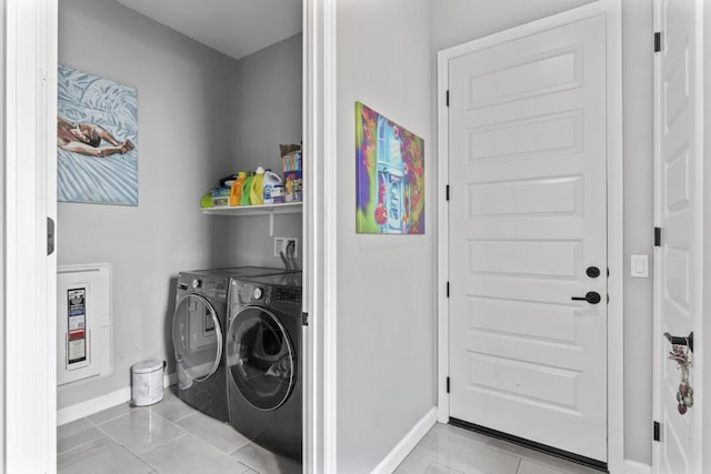 laundry area with light tile patterned floors and washer and clothes dryer