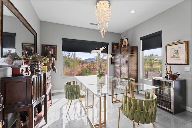 tiled dining space with wine cooler and an inviting chandelier