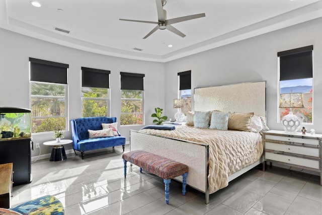 tiled bedroom with multiple windows and ceiling fan