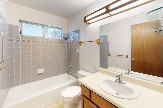 full bathroom with toilet, vanity, and tiled shower / bath