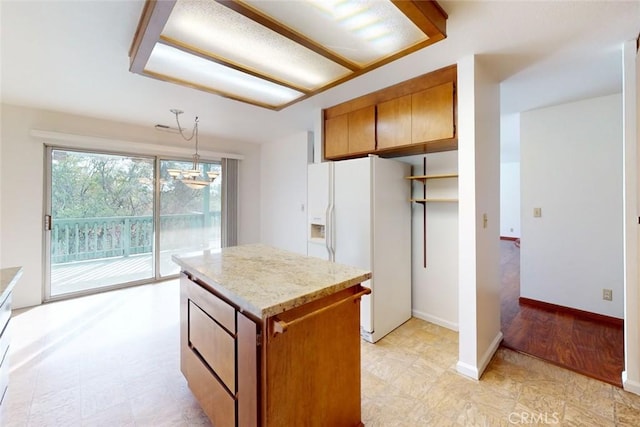 kitchen featuring decorative light fixtures, a chandelier, a center island, light hardwood / wood-style floors, and white fridge with ice dispenser