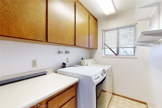 clothes washing area featuring cabinets and independent washer and dryer