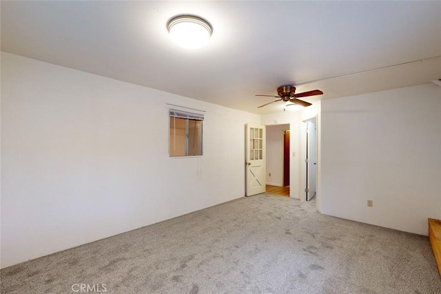 unfurnished room featuring light colored carpet and ceiling fan