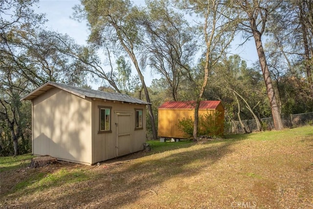 view of outbuilding featuring a lawn