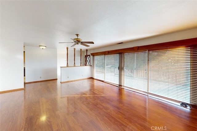 unfurnished room with ceiling fan and hardwood / wood-style flooring