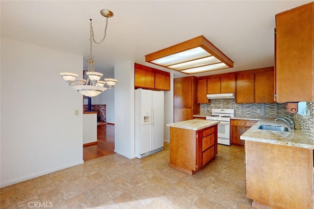 kitchen with white appliances, sink, a notable chandelier, a center island, and hanging light fixtures