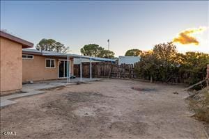 yard at dusk with a patio area