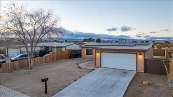 ranch-style house with solar panels and a garage