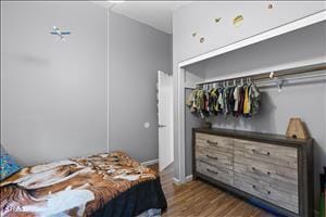 bedroom with dark hardwood / wood-style flooring