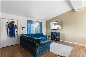 living room with hardwood / wood-style floors and vaulted ceiling