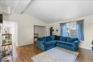 living room with hardwood / wood-style floors and vaulted ceiling with beams