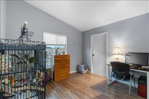 home office with hardwood / wood-style flooring and lofted ceiling