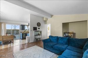 living room with vaulted ceiling with beams and hardwood / wood-style floors