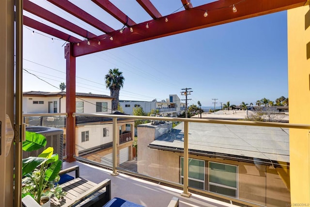 balcony featuring a pergola and central air condition unit