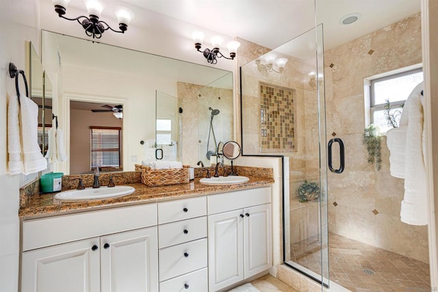 bathroom with ceiling fan, vanity, and a shower with shower door