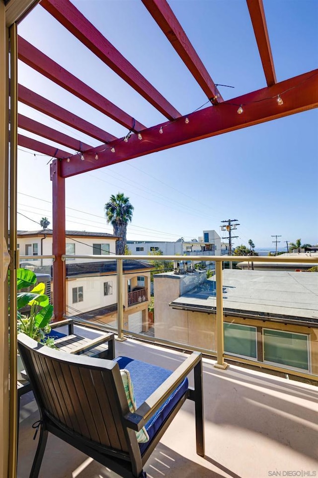 view of patio / terrace with a pergola and a balcony