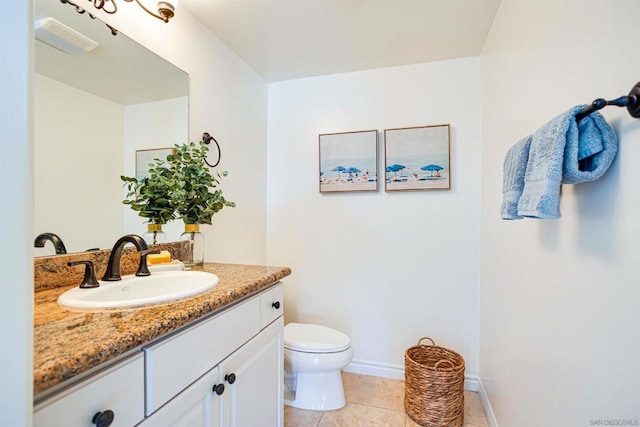 bathroom with vanity, tile patterned floors, and toilet