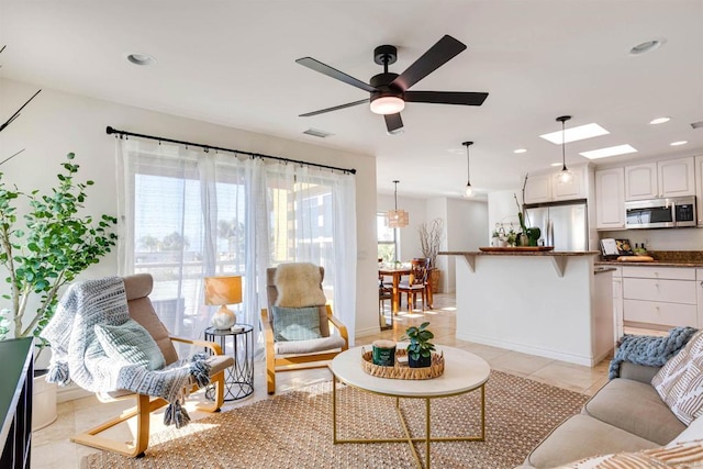 living room featuring ceiling fan and light tile patterned floors