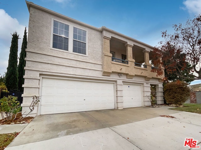 view of front of home featuring a balcony and a garage