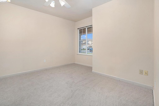 carpeted empty room featuring ceiling fan